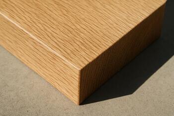 Noon light drawing a sharp edge on oak