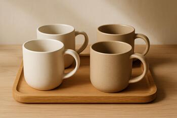 Warm matte mugs arranged on an oak tray