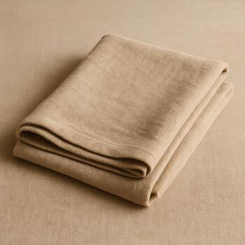 Oat-colored tea cloth folded neatly