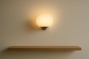 Soft wall sconce above a narrow shelf